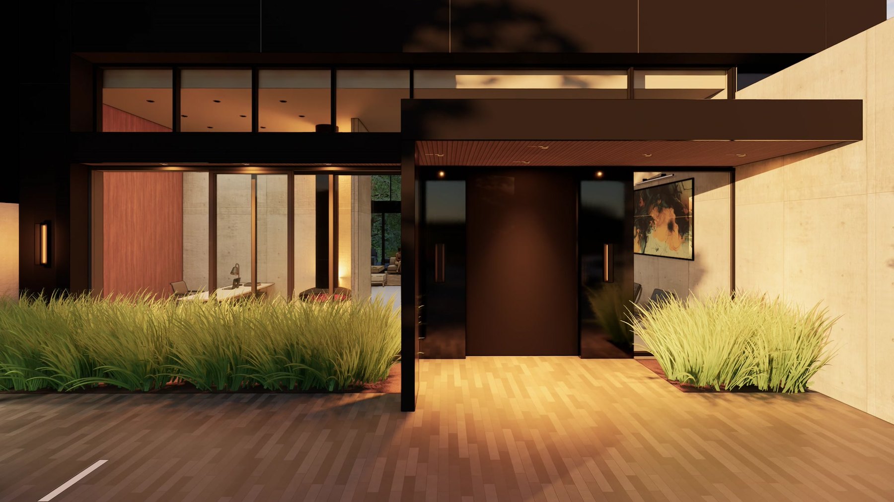 Main entry at night beneath a deep dark canopy with a warm timber soffit, flanked by sand-colored walls and ornamental grasses